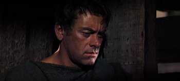 Movie still from “Spartacus” (1960), directed by Stanley Kubrick – A person wearing a black shirt; Close Up shot, High angle