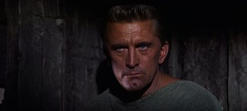 Movie still from “Spartacus” (1960), directed by Stanley Kubrick – A person wearing a t - shirt; Close Up shot, Low angle