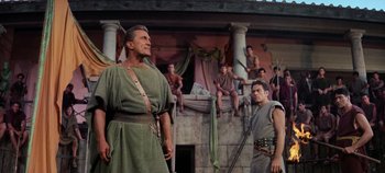 Movie still from “Spartacus” (1960), directed by Stanley Kubrick – A group of men standing next to each other on top of a building; Medium shot, Low angle