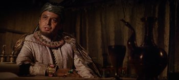 Movie still from “Spartacus” (1960), directed by Stanley Kubrick – A man wearing a crown and a robe; Medium shot, Low angle