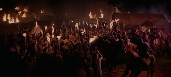 Movie still from “Spartacus” (1960), directed by Stanley Kubrick – A group of people holding torches in the dark; Extreme Wide shot, High angle