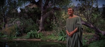 Movie still from “Spartacus” (1960), directed by Stanley Kubrick – A man dressed in ancient roman clothing standing next to a body of water; Medium shot, Low angle
