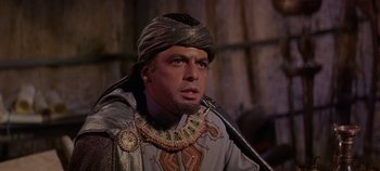 Movie still from “Spartacus” (1960), directed by Stanley Kubrick – A man wearing a head dress and a necklace; Close Up shot, High angle