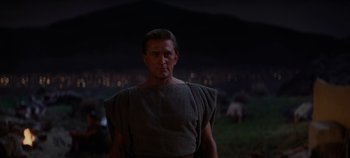 Movie still from “Spartacus” (1960), directed by Stanley Kubrick – A man wearing a toga around his shoulders; Medium shot, Low angle