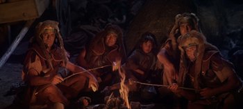 Movie still from “Spartacus” (1960), directed by Stanley Kubrick – A group of people sitting around a fire; Medium shot, High angle