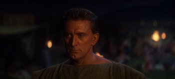 Movie still from “Spartacus” (1960), directed by Stanley Kubrick – A person wearing a robe; Close Up shot, Over the shoulder angle