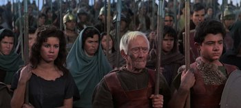 Movie still from “Spartacus” (1960), directed by Stanley Kubrick – An old man with a white beard is in a crowd of people; Medium shot, High angle