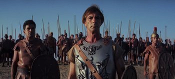 Movie still from “Spartacus” (1960), directed by Stanley Kubrick – A group of men in ancient roman garb stand together; Close Up shot, Low angle