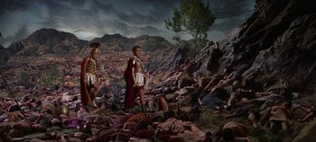 Movie still from “Spartacus” (1960), directed by Stanley Kubrick – A group of men in roman garb walking through a field of corpses; Extreme Wide shot, High angle