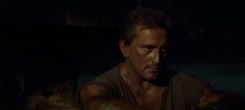 Movie still from “Spartacus” (1960), directed by Stanley Kubrick – A person with a chain around his neck; Close Up shot, Low angle