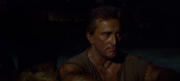 Movie still from “Spartacus” (1960), directed by Stanley Kubrick – A person wearing a brown shirt; Close Up shot, Low angle