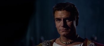 Movie still from “Spartacus” (1960), directed by Stanley Kubrick – A person wearing a necklace; Close Up shot, Low angle