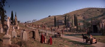 Movie still from “Spartacus” (1960), directed by Stanley Kubrick – A group of people standing on top of a grass covered field; Extreme Wide shot, High angle