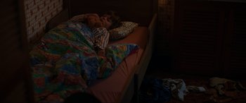 Movie still from “Speak No Evil” (2022), directed by Christian Tafdrup – A little girl laying in a bed with a teddy bear; Medium shot, High angle