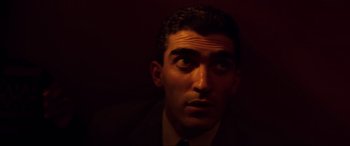 Movie still from “Speed” (1994), directed by Jan de Bont – A person wearing a suit and tie; Close Up shot, High angle