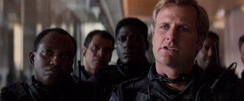 Movie still from “Speed” (1994), directed by Jan de Bont – A group of men standing next to each other on a train; Close Up shot, Low angle