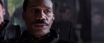 Movie still from “Speed” (1994), directed by Jan de Bont – A person wearing a headset; Close Up shot, Low angle