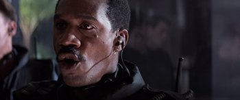 Movie still from “Speed” (1994), directed by Jan de Bont – A person wearing headphones; Close Up shot, Low angle