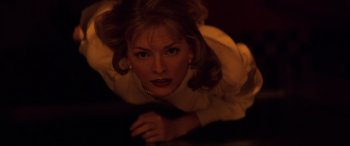 Movie still from “Speed” (1994), directed by Jan de Bont – A woman in a white shirt is laying on the ground; Close Up shot, Overhead angle