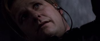 Movie still from “Speed” (1994), directed by Jan de Bont – A person wearing a headset; Close Up shot, Low angle