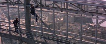 Movie still from “Speed” (1994), directed by Jan de Bont – A man is on a ladder on a building; Wide shot, Overhead angle
