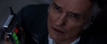Movie still from “Speed” (1994), directed by Jan de Bont – An older man looking into the distance with a serious look on his face; Close Up shot, Low angle