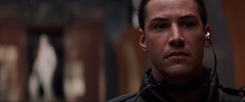 Movie still from “Speed” (1994), directed by Jan de Bont – A person wearing a black jacket; Close Up shot, Over the shoulder angle