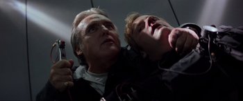 Movie still from “Speed” (1994), directed by Jan de Bont – A man and a boy are looking up at the sky; Close Up shot, Low angle