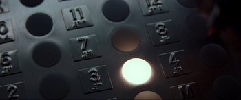 Movie still from “Speed” (1994), directed by Jan de Bont – View of a button on a building; Extreme Close Up shot, Overhead angle