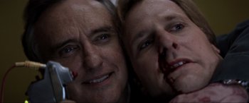Movie still from “Speed” (1994), directed by Jan de Bont – A man and a woman with blood on their faces; Close Up shot, Overhead angle