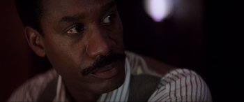 Movie still from “Speed” (1994), directed by Jan de Bont – A man with a mustache; Close Up shot, Low angle