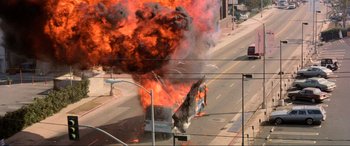 Movie still from “Speed” (1994), directed by Jan de Bont – A truck on fire on the side of the road; Extreme Wide shot, High angle