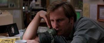 Movie still from “Speed” (1994), directed by Jan de Bont – A man sitting down talking on a phone; Close Up shot, Low angle