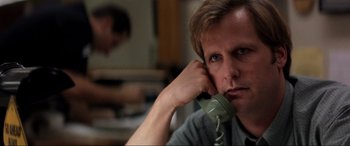 Movie still from “Speed” (1994), directed by Jan de Bont – A man sitting at a desk holding a phone to his ear; Close Up shot, Low angle
