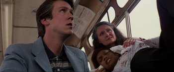 Movie still from “Speed” (1994), directed by Jan de Bont – A man and two women on a bus; Close Up shot, Low angle