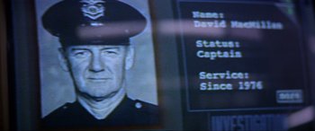 Movie still from “Speed” (1994), directed by Jan de Bont – A person wearing a uniform; Extreme Close Up shot, Low angle