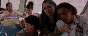 Movie still from “Speed” (1994), directed by Jan de Bont – A group of people sitting in a car; Close Up shot, Over the shoulder angle