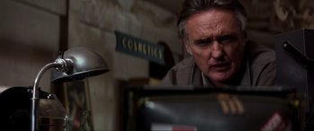 Movie still from “Speed” (1994), directed by Jan de Bont – An older man is looking at a computer screen; Close Up shot, Low angle