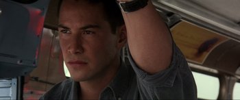 Movie still from “Speed” (1994), directed by Jan de Bont – A person with his arm up; Close Up shot, Low angle