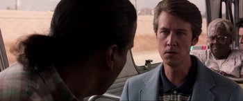 Movie still from “Speed” (1994), directed by Jan de Bont – Two men in suits are talking in a car; Close Up shot, Over the shoulder angle