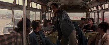 Movie still from “Speed” (1994), directed by Jan de Bont – A group of people riding on a public transit bus; Medium shot, Low angle