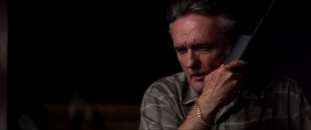 Movie still from “Speed” (1994), directed by Jan de Bont – A person with his hand on his chin; Close Up shot, High angle