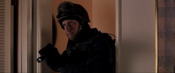 Movie still from “Speed” (1994), directed by Jan de Bont – A man wearing a helmet and a black jacket; Medium shot, Low angle