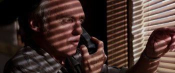 Movie still from “Speed” (1994), directed by Jan de Bont – A person talking on a cell phone; Close Up shot, Low angle