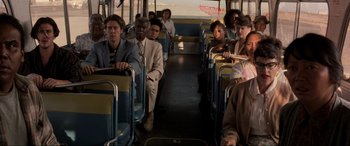 Movie still from “Speed” (1994), directed by Jan de Bont – A group of men and women sitting on a bus; Wide shot, High angle