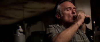 Movie still from “Speed” (1994), directed by Jan de Bont – An older man sitting in front of a window; Close Up shot, Low angle