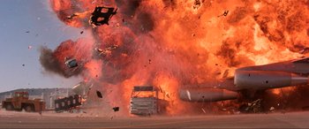 Movie still from “Speed” (1994), directed by Jan de Bont – A truck that has been set on fire by an explosion; Extreme Wide shot, Low angle