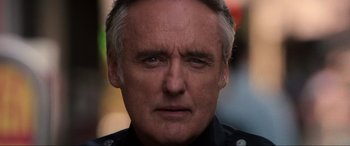 Movie still from “Speed” (1994), directed by Jan de Bont – A police officer's face; Close Up shot, Low angle