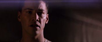 Movie still from “Speed” (1994), directed by Jan de Bont – A man's face in the dark; Close Up shot, Low angle