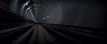 Movie still from “Speed” (1994), directed by Jan de Bont – A train tunnel with lights and tracks running through it; Extreme Wide shot, Overhead angle